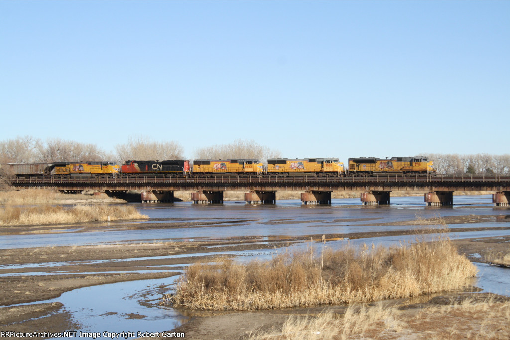 UP 8716 leads a lengthy manifest east over the Platte River on the Marysville Subdivision